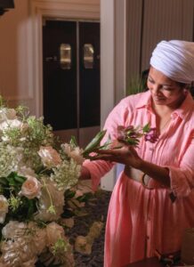 Juha Qureshi, leading wedding decorator in Michigan, arranging fresh floral decor at The Mirage for luxury wedding under the banner of Bridal Insignia Events