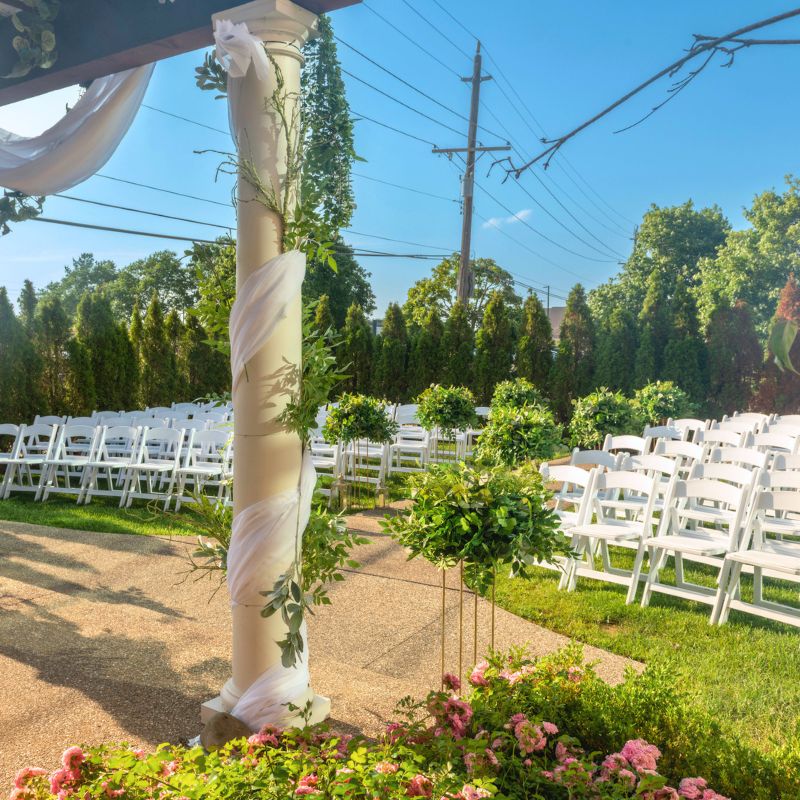 Luxury wedding gazebo Michigan at The Mirage decorated by Bridal Insignia Events with cascading florals and custom ceremony backdrop